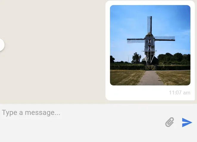 Chat message with a photo of a Dutch windmill sent to a coach
