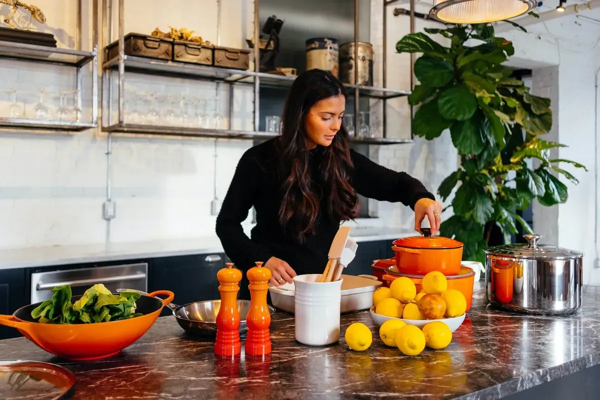 Woman preparing a healthy meal with fresh lemons in her kitchen