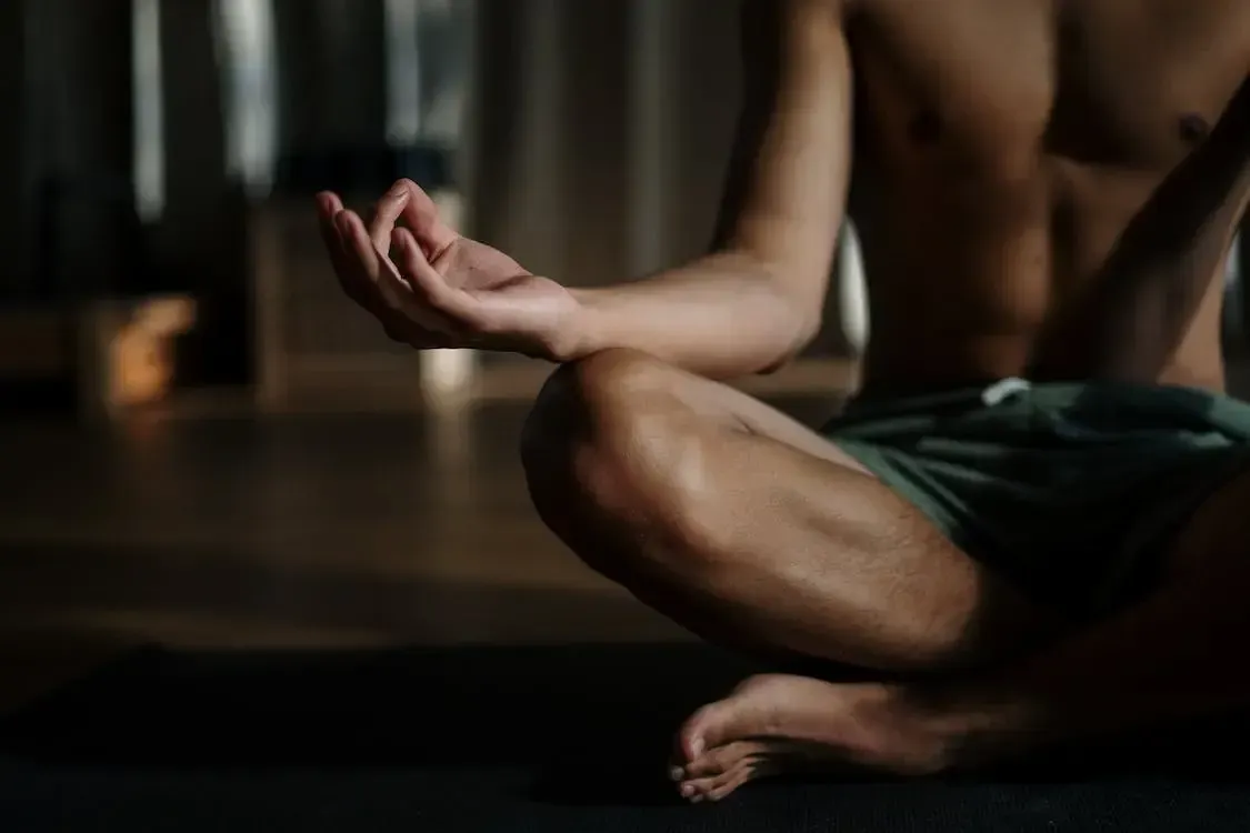 Close-up of a person meditating cross-legged