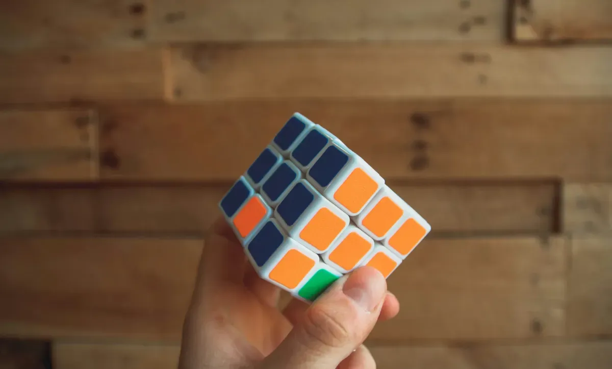 Hand holding a partially solved Rubik's cube