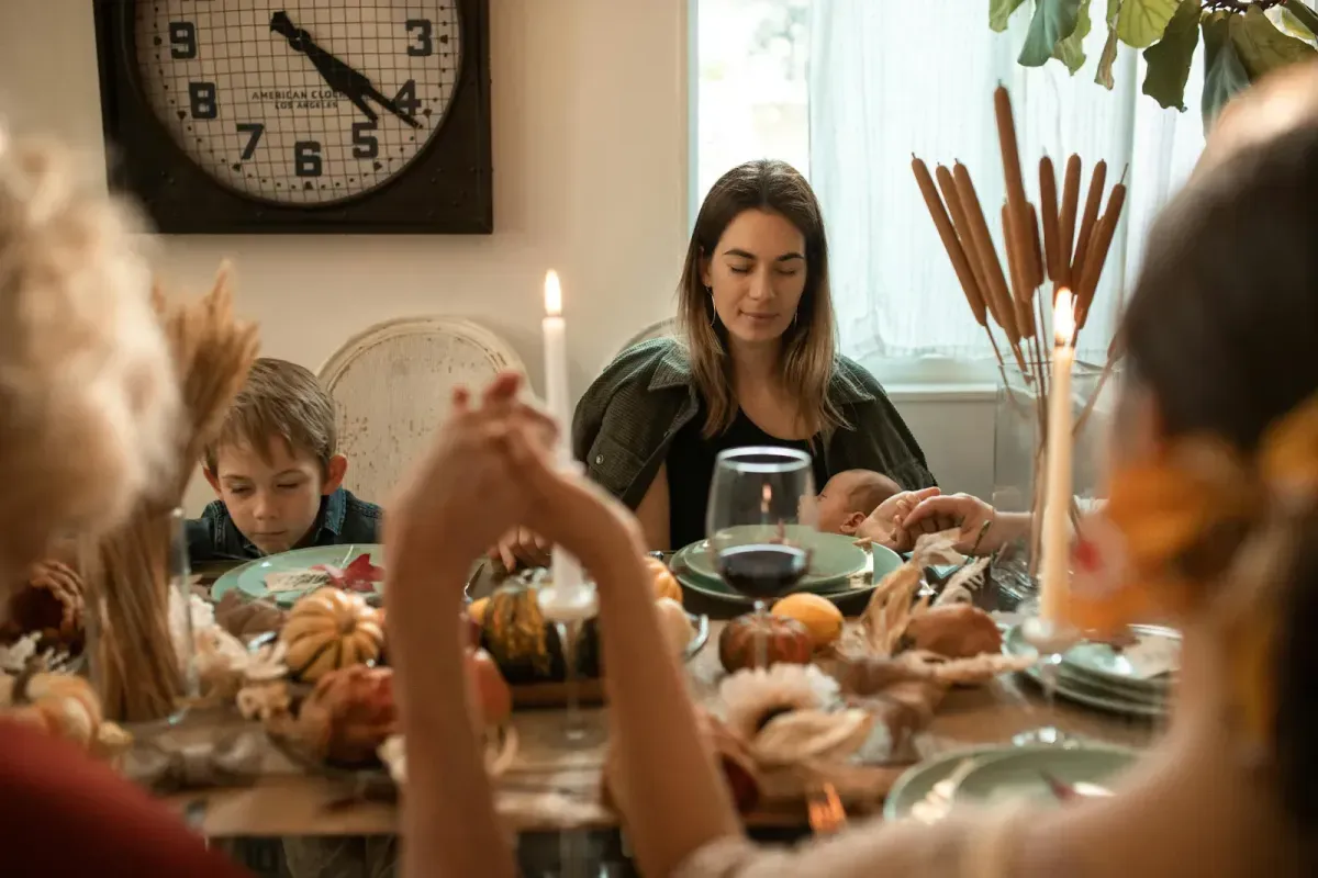 family gathered around a candlelit dinner table