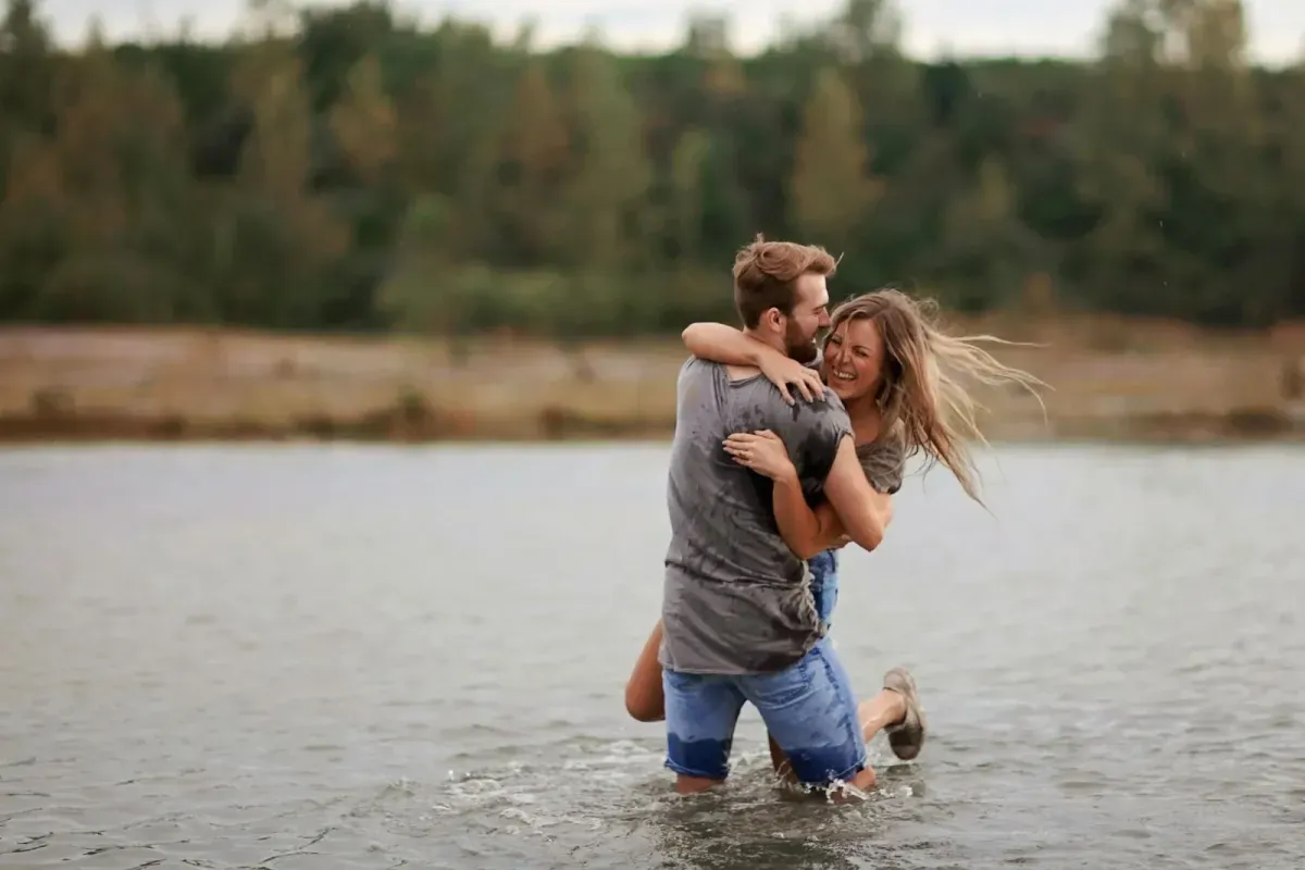 A free stock photo of a couple holding eachother in water