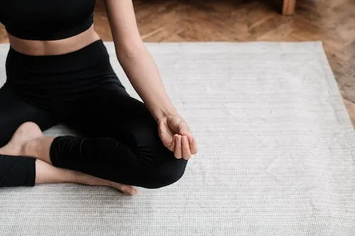 Free Woman in Black Tank Top and Leggings in Yoga Position Stock Photo
